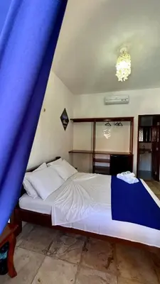 Uma cama ou camas num quarto em Pousada Califórnia Tia Lia