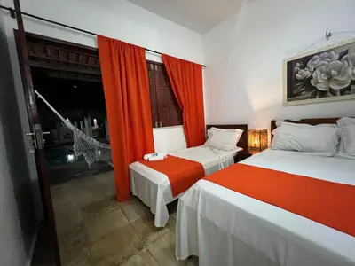 Uma cama ou camas num quarto em Pousada Califórnia Tia Lia