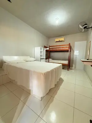 Uma cama ou camas num quarto em Pousada Sol Dourado