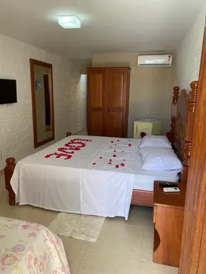 Uma cama ou camas num quarto em Pousada Lua Vermelha