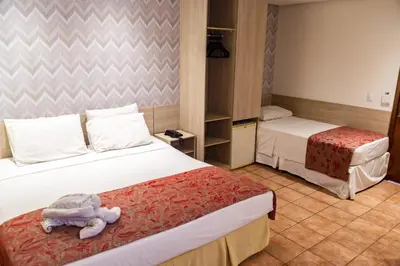 Uma cama ou camas num quarto em Plaza Praia Suítes