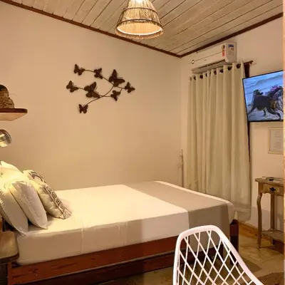 Uma cama ou camas num quarto em Pousada Carioca - Pousada de Charme