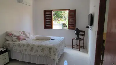 Uma cama ou camas num quarto em Pousada da Lucinha