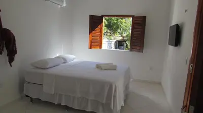 Uma cama ou camas num quarto em Pousada da Lucinha