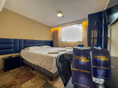 Uma cama ou camas num quarto em Pecém Hotel