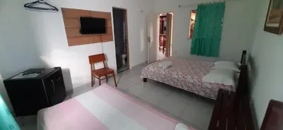 Uma cama ou camas num quarto em Pousada Casa da Lucinha
