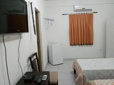 Uma televisão e/ou sistema de entretenimento em Pousada Casa da Lucinha