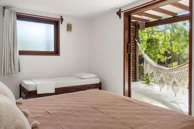 Uma cama ou camas num quarto em Pousada Pais Tropical