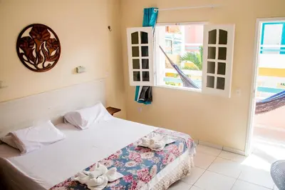 Uma cama ou camas num quarto em Pousada Angelica