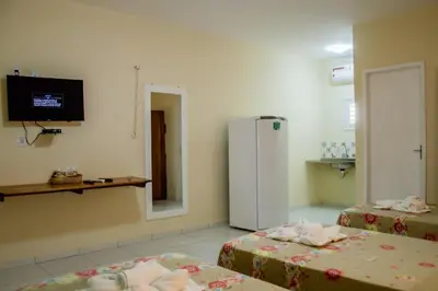 Uma cama ou camas num quarto em Pousada Angelica