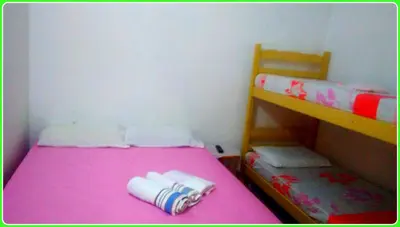 Uma cama ou camas num quarto em Hospedaria Praia e Sol