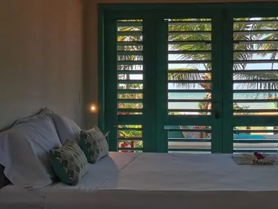 Uma cama ou camas num quarto em La Villa Tropicale linda casa pertinho do mar !