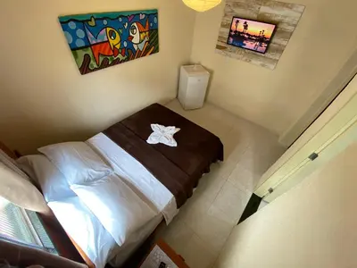 Uma cama ou camas num quarto em Refúgio Pousada Fortaleza