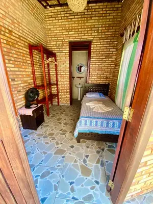 Uma cama ou camas num quarto em Casa Cumbuco e Hospedaria