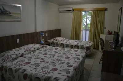 Uma cama ou camas num quarto em Hotel Casa De Praia