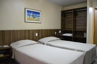 Uma cama ou camas num quarto em Hotel Casa De Praia