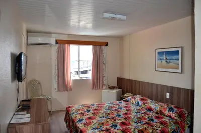 Uma cama ou camas num quarto em Hotel Casa De Praia