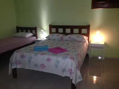 Uma cama ou camas num quarto em Pousada Muiraquitã