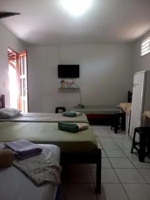 Uma cama ou camas num quarto em Suítes Centro Praia