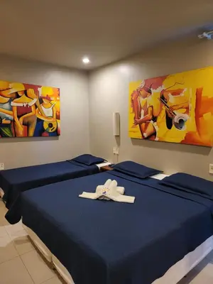 Uma cama ou camas num quarto em Hotel Encontro do Sol