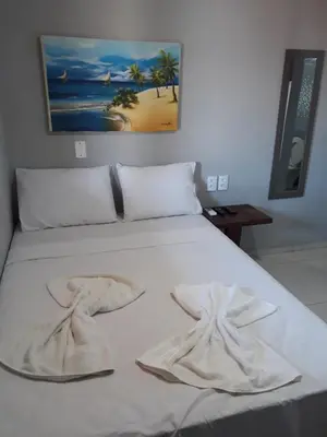 Uma cama ou camas num quarto em Suítes Canaã
