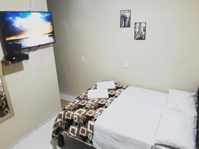 Uma cama ou camas num quarto em Suítes Canaã