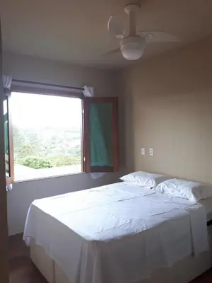 Uma cama ou camas num quarto em Guaramiranga Monte Verde