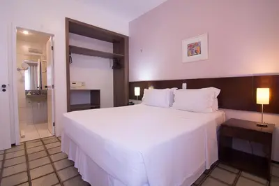 Uma cama ou camas num quarto em Nobile Suítes Golden Fortaleza