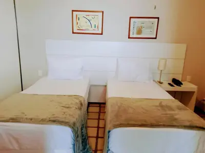 Uma cama ou camas num quarto em Nobile Suítes Golden Fortaleza