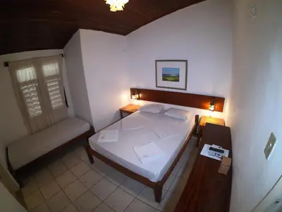 Uma cama ou camas num quarto em Pousada Casa Do Angelo