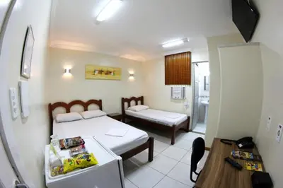 Uma cama ou camas num quarto em Hotel Belem Fortaleza