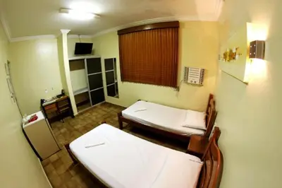 Uma cama ou camas num quarto em Hotel Belem Fortaleza