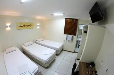 Uma cama ou camas num quarto em Hotel Belem Fortaleza
