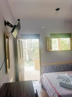 Uma cama ou camas num quarto em Pousada Fortaleza