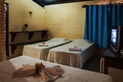 Uma cama ou camas num quarto em Pousada California