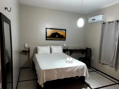 Uma cama ou camas num quarto em Pousada Alternativa