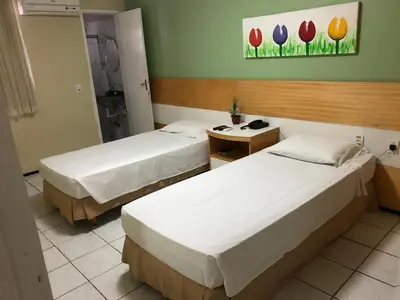Uma cama ou camas num quarto em Raio de Sol Praia Hotel