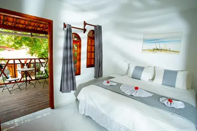 Uma cama ou camas num quarto em Pousada Villa Caju