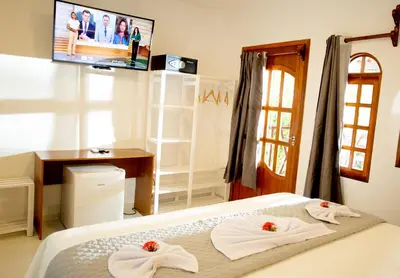 Uma cama ou camas num quarto em Pousada Villa Caju