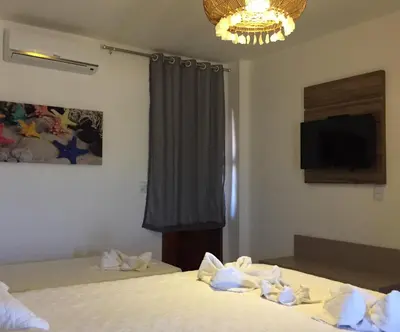 Uma cama ou camas num quarto em Pousada Portal da Ilha