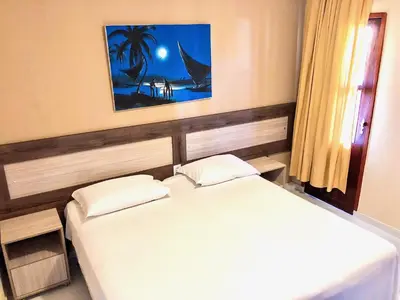 Uma cama ou camas num quarto em Pousada Portal da Ilha