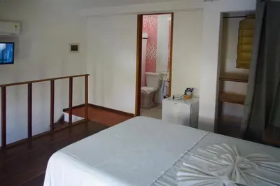 Uma cama ou camas num quarto em Pousada Presidente Hotel
