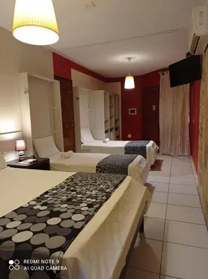 Uma cama ou camas num quarto em Pousada Presidente Hotel