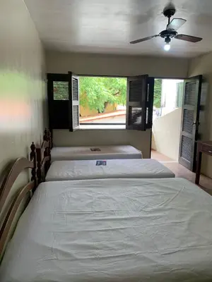 Uma cama ou camas num quarto em Pousada Malu