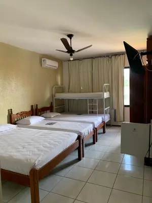 Uma cama ou camas num quarto em Pousada Malu