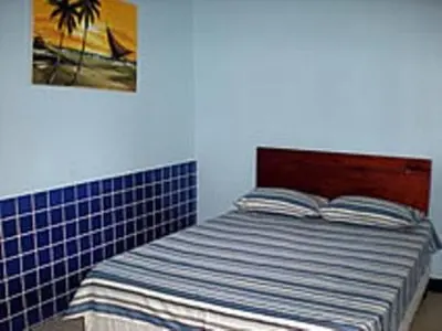Uma cama ou camas num quarto em Pousada Azul da Broadway