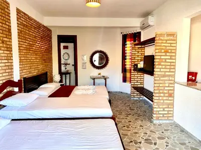 Uma cama ou camas num quarto em Hotel e Pousada Cumbuco Guesthouse