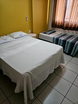 Uma cama ou camas num quarto em Porto de Iracema - 611 Frente mar