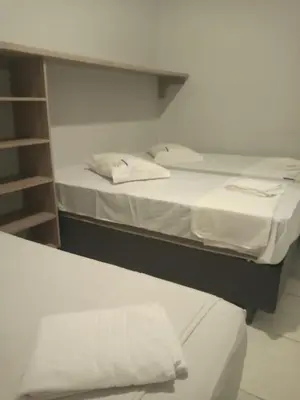 Uma cama ou camas num quarto em Pousada Dragao Do Mar