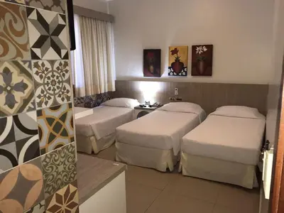 Uma cama ou camas num quarto em Aldeota Praia Hotel